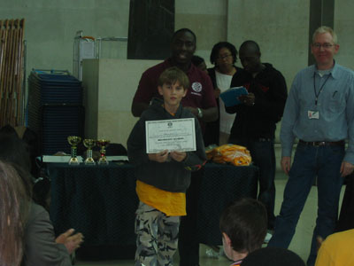 Joshua Frisby receiving his certificate of participation.